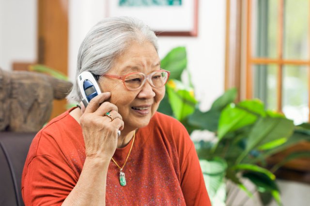 Chinese Asian Senior Woman Talking on Telephone, Holding Mobile Phone