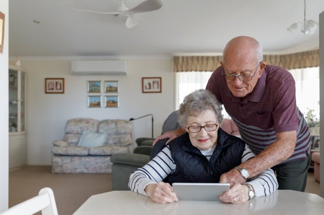 Senior Australian Couple Learning To Use Digital Tablet