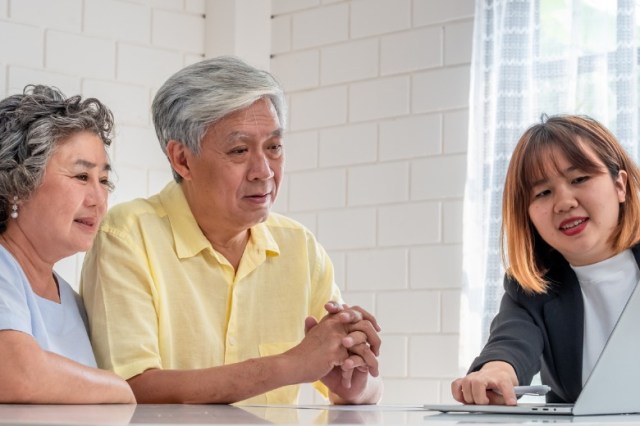 asian-senior-couple-with-financial-advisor-about-tax-and-retirement-picture-id1145853873