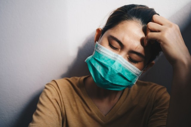 depressed-woman-having-headache-after-failure-and-layoff-from-work-picture-id1282408303
