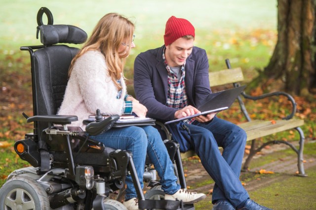 student-helping-friend-with-disability-picture-id680248362