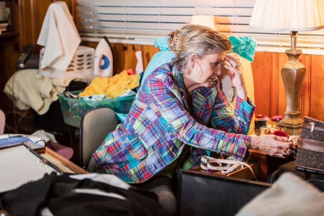 Senior woman at home, messy room