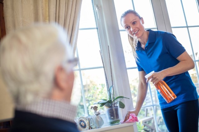 female-home-help-cleaning-house-for-senior-man-picture-id1190833104