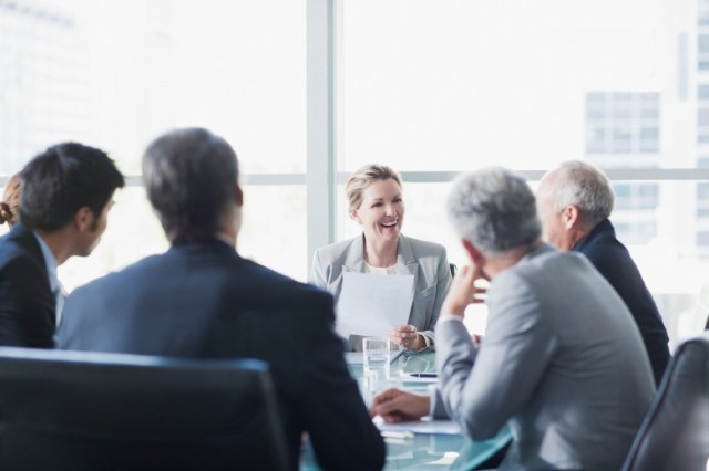 smiling-businesswoman-leading-meeting-in-conference-room-picture-id147205287