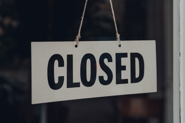 Closed sign on a glass front door of a restaurant.