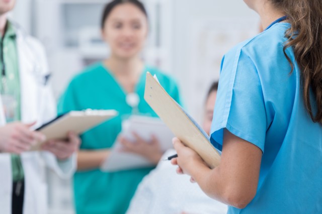Medical students in patient's hospital room