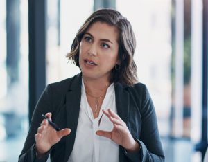 Business woman, interview and discussion at office for deal, agreement or contract for b2b collaboration. People, staff and meeting in negotiation for question, human resources and decision at job