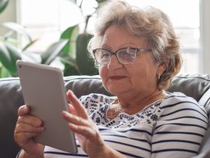 Senior woman using wireless tablet